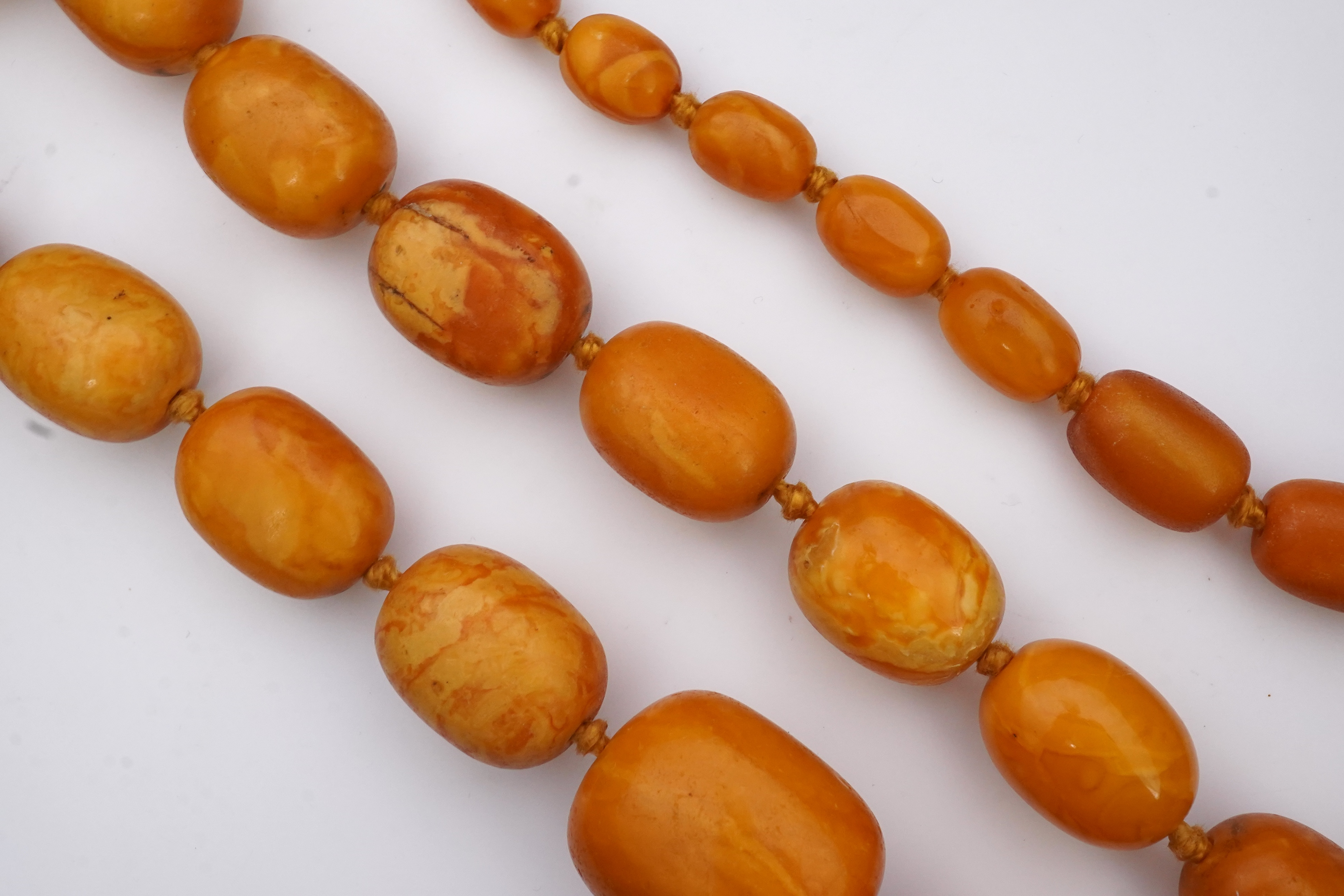 A single strand graduated oval amber bead necklace